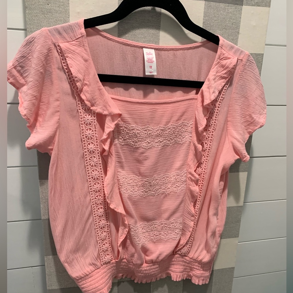 Justice, pink flowy blouse with stitching details.  Elastic at the waist.